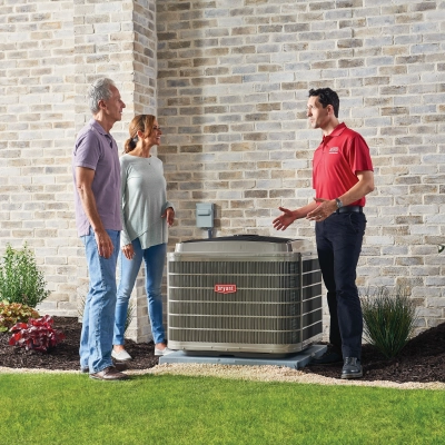 bryant HVAC tech talking with couple outdoor